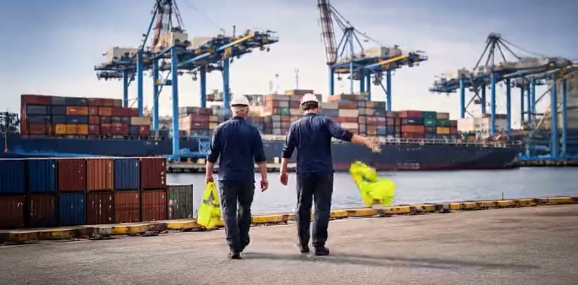 Technicians walking toward the cranes at the Port of Ashdod
